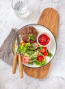 Beef hamburger with lettuce tomato salad on white plate, top view Royalty Free Stock Photo