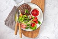 Beef hamburger with lettuce tomato salad on white plate, top view Royalty Free Stock Photo