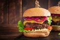 Hamburger. Sandwich with beef burger, tomatoes, cheese, pickled cucumber and lettuce. Cheeseburger Royalty Free Stock Photo