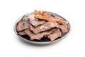 Beef jerky meat on plate. Dried sliced meat isolated on white background