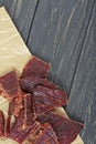 Beef jerky on wooden board, close-up