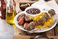 Beef kebab with rice, beans and fried plantains