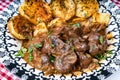 Beef kidney, leek and onion stew with Spanish style potatoes served on a vintage plate Royalty Free Stock Photo