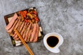 Beef Korean grilled beef made thinly sirloin of steak fried in red bell peppers and mushrooms on plate with chopsticks Royalty Free Stock Photo