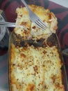 Beef Lasagne home made dish served in glass tray on the black table in lockdown days of covid 19