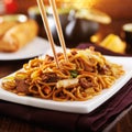 Beef lo mein with chopsticks