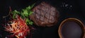 Beef medallion steak with vegetables and sauce on a black background Royalty Free Stock Photo
