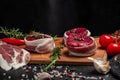 Beef medallions wrapped in bacon with rosemary and spices, Raw beef meat steak Tenderloin fillet on a cutting board. Top view.