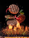 Beef milled meat on hamburger with spices fly over the flaming grill barbecue fire Royalty Free Stock Photo