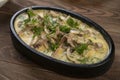 beef, mushroom in cream sauce on dark wood