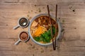 Beef noodle soup with vegetables, traditional Chinese food with soy and chili sauce on the side Royalty Free Stock Photo