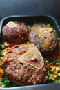 Beef ossobuco meat on tray with crushed vegetables Royalty Free Stock Photo