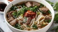 Beef Pho Noodle Soup with Fresh Herbs and Chili