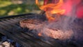 Beef or pork meat barbecue burgers for hamburger prepared grilled on bbq fire flame grill. Tasty meat for burger cooked Royalty Free Stock Photo