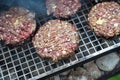 Beef or pork meat barbecue burgers for hamburger prepared grilled on bbq smoke grill in garden Royalty Free Stock Photo