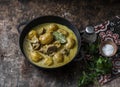 Beef potato massaman curry in a frying pan on wooden background, top view. Comfort, delicious food Royalty Free Stock Photo