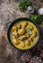 Beef potato massaman curry in a frying pan on wooden background, top view. Comfort, delicious food Royalty Free Stock Photo