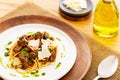 Beef ragout sauce spaghetti pasta with tomatoes, basil and pesto. Aside a spoon, a bottle of olive oil and parmesan. Royalty Free Stock Photo