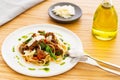 Beef ragout sauce spaghetti pasta with tomatoes, basil and pesto. With cutlery on the side and olive oil. Royalty Free Stock Photo