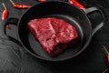 Beef raw rump steak with salt pepper rosemary, on black dark stone table background Royalty Free Stock Photo