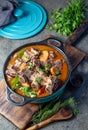 Beef ribs Bourguignonne in blue casserole. Homemade beef stew with vegetables and red wine Royalty Free Stock Photo