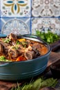 Beef ribs Bourguignonne in blue casserole. Homemade beef stew with vegetables and red wine Royalty Free Stock Photo