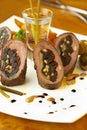 Beef rolls with prunes, cheese and pine nuts