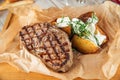 Beef steak with baked potatoes with sour cream