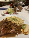 beef steak covered with gravy and chanterelle mushrooms served with spaetzle a tradional bavarian and austria pasta