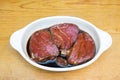 Beef steak eye fillet meat marinading in white dish of soy sauce