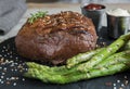 Beef steak grilled with asparagus tomatoes spice and sauce Royalty Free Stock Photo