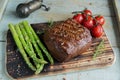 Beef steak grilled with asparagus tomatoes spice on a wooden surface