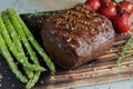 Beef steak grilled with asparagus tomatoes spice on a wooden surface