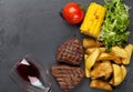 Beef steak with grilled potato, corn, salad and red wine Royalty Free Stock Photo