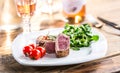 Beef Steak. Juicy beef steak. Gourmet steak with vegetables and glass of rose wine on wooden table Royalty Free Stock Photo