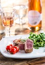 Beef Steak. Juicy beef steak. Gourmet steak with vegetables and glass of rose wine on wooden table Royalty Free Stock Photo