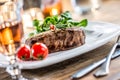 Beef Steak. Juicy beef steak. Gourmet steak with vegetables and glass of rose wine on wooden table Royalty Free Stock Photo