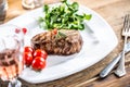 Beef Steak. Juicy beef steak. Gourmet steak with vegetables and glass of rose wine on wooden table Royalty Free Stock Photo