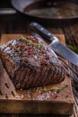 Beef steak. Juicy Rib Eye steak in pan on wooden board with herb and pepper Royalty Free Stock Photo