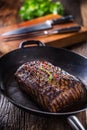 Beef steak. Juicy Rib Eye steak in pan on wooden board with herb and pepper Royalty Free Stock Photo