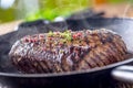 Beef steak. Juicy Rib Eye steak in pan on wooden board with herb and pepper Royalty Free Stock Photo