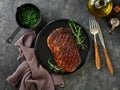 Beef Steak medium rare on black plate, surfed with tableware on black stone table with ample copy space. Dark background. Royalty Free Stock Photo
