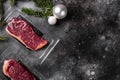 Beef steak pack, on black dark stone table background, top view flat lay, with copy space for text Royalty Free Stock Photo