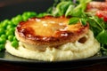 Beef steak pies with rich onion gravy served with sweet peas and salad Royalty Free Stock Photo