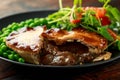 Beef steak pies with rich onion gravy served with sweet peas and salad Royalty Free Stock Photo