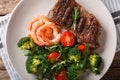 Beef steak with prawns and broccoli, tomatoes, arugula closeup o Royalty Free Stock Photo