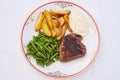 Beef steak with roasted potatoes, boiled green beans and tartar sauce.