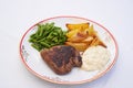 Beef steak with roasted potatoes, green beans and tartar sauce. Royalty Free Stock Photo