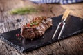 Beef Steak. Roasted Beef steak with salt pepper thyme on rustic wooden table