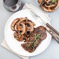 Beef steak with sauteed brown mushrooms and thyme, top view, square